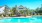 a swimming pool with a house in the background