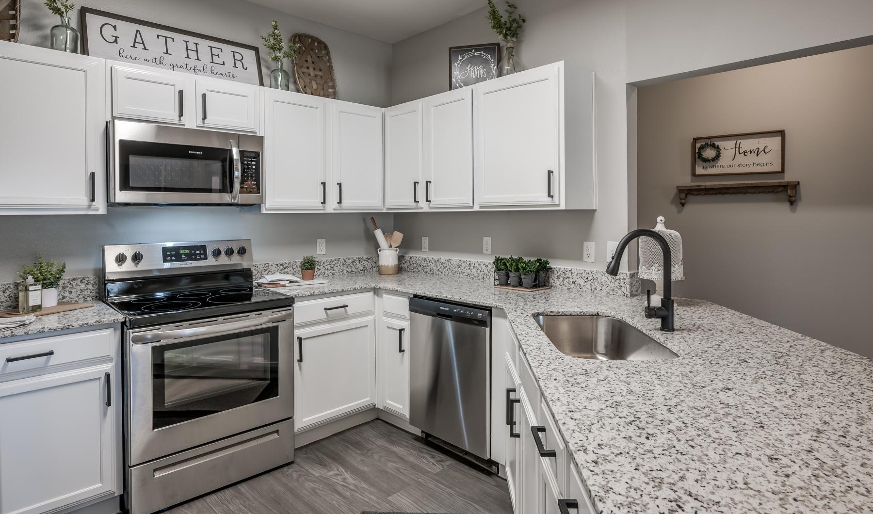 Settle into comfort at Woodland Landings a kitchen with white cabinets